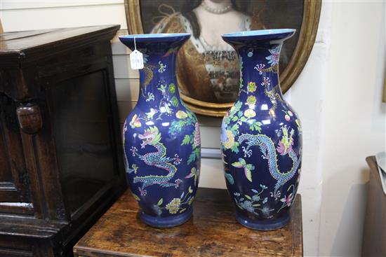 A pair of large Chinese blue ground dragon and phoenix vases, 19th century, restorations